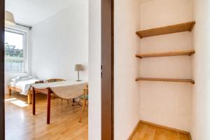a room with white walls and a table and a window at Dusan Apartments in Orlová