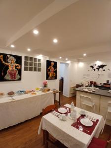 a living room with two tables and a kitchen at B&B Italian Guest Genova in Genoa
