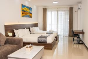 a hotel room with a bed and a couch at A One Oasis River View Hotel in Phnom Penh +48 photos