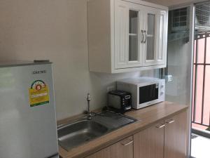 a kitchen with a sink and a microwave at D Condo Kathu-Patong Phuket by Jacky in Kathu