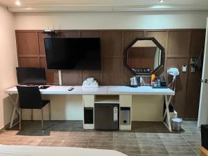 a desk with a monitor and a computer on it at Sixty Hotel in Seoul +48 photos