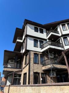 a building with balconies on the side of it at Къща за гости Девина in Devin