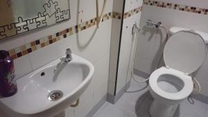 a bathroom with a toilet and a sink at Batu Caves Paradise Hotel in Kuala Lumpur