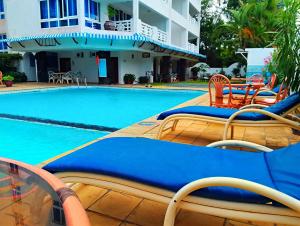 a swimming pool with chairs and a hotel at The Initial Residence in Mombasa