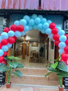 a bunch of blue and red balloons in a doorway at Natalie's Homestay Bed and Breakfast in El Nido
