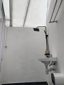 a white bathroom with a sink and a shower at Ohara Glamping in Kubupenlokan