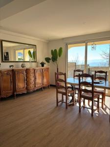 a dining room with a table and chairs and a mirror at la casa bella vista in Enval +47 photos