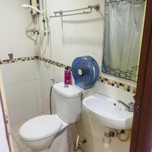 a small bathroom with a toilet and a sink at Batu Caves Paradise Hotel in Kuala Lumpur