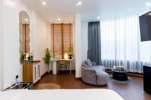 a living room with a bed and a couch and a table at Sài Gòn Heat Hotel in Ho Chi Minh City +78 photos