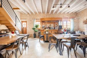 a large dining room with wooden tables and chairs at B&B Des Histoires d'Anges - Côté Jardin - Accueil Vélo in Tournus