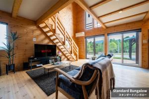 a living room with a couch and a tv at Rusutsu Hills CENTRO in Rusutsu