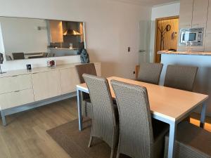 a kitchen and dining room with a table and chairs at romanza 104 in Middelkerke
