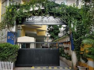 an entrance to a building with a sign that reads inn suites and suites at HM Suites & Studios in Bangalore