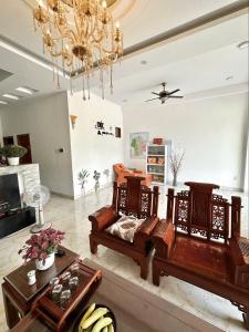 a living room with wooden furniture and a chandelier at Moc homestay- Near Bai Dai Beach in Cam Lâm