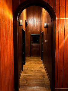 a hallway of a building with wooden walls and a door at Udadola Ecolodge in Deniyaya