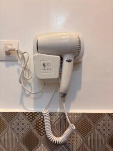 a hairdryer is plugged into a wall at The Ivory Castle in Pooc
