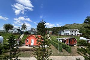 a group of houses and a red house at Honey Queen Resort in Ban Tha Manao
