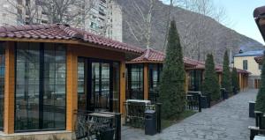 a building with glass doors and a tiled roof at Prince Hotel Kapan in Kapan