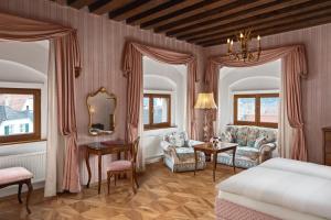 a bedroom with a bed and a table and chairs at Hotel Schloss Dürnstein in Dürnstein +179 photos