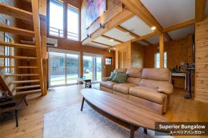 a living room with a couch and a table at Rusutsu Hills CENTRO in Rusutsu +34 photos