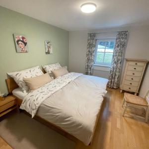 a bedroom with a large white bed and a window at Chalet Milanovic in Dalaas