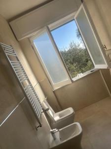 a bathroom with a toilet and a window at Casa Mina in Lavagna +39 photos