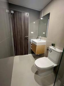 a bathroom with a toilet and a sink and a mirror at The8collaction in Bangkok +9 photos