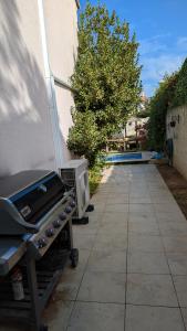 a grill sitting on a sidewalk next to a building at Quiet house in Aubagne