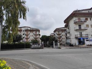 an empty street with two tall apartment buildings at Appartamento Stefano in Scalea
