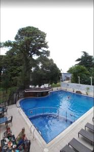 a large swimming pool with people sitting around it at Hotel AnOrita in Kobuleti