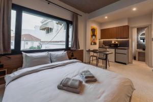 a bedroom with a large bed with towels on it at Frourio Lodge B2 in Larisa