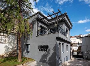 a building with a balcony on top of it at Frourio Lodge B2 in Larisa