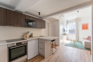a kitchen with a counter and a living room at Petit Levant in La Ciotat