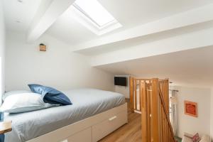 a bedroom with a bed and a skylight at Petit Levant in La Ciotat