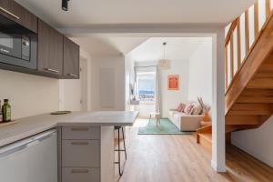 a kitchen with a counter and a living room at Petit Levant in La Ciotat +9 photos