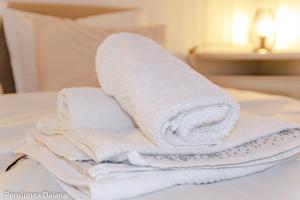 a pile of towels sitting on top of a bed at Vila Daiana- Acceptam vouchere vacanta in Moieciu de Jos +69 photos