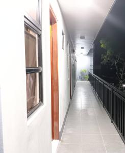 an empty hallway of a building with a window at MartiVille Residences in Gloria +5 photos