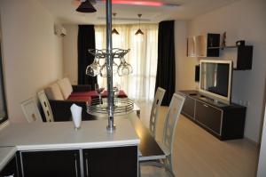 a room with a dining table and a living room at Black Sea Brееze Apartment in Varna City