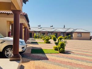 a car parked in front of a building at BotseBontle Lodge in Lenting