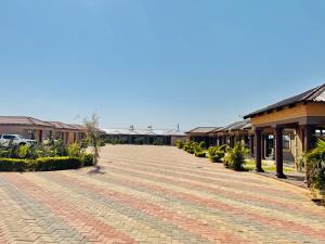 a brick road in front of a building at BotseBontle Lodge in Lenting