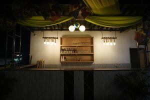 a bar in a restaurant with lights on the wall at Frolic Hotel Near Sec 52 Noida Metro Station in Noida