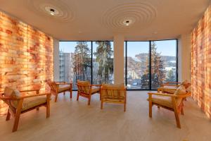 a room with chairs and tables and large windows at Hotel Podgorie Spa in Bukovel +125 photos