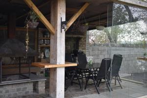 a patio with a table and chairs and a stone wall at Alensgrove Maisonette C in Leixlip