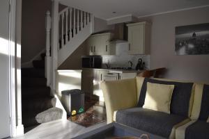 a living room with a couch and a kitchen at Alensgrove Maisonette C in Leixlip +42 photos