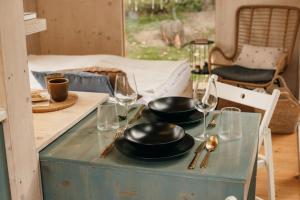 a table with two pans and wine glasses on it at Útulna Rychleby in Vápenná