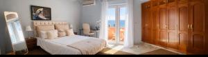 a bedroom with a bed with a view of the ocean at Villa Alma Boutique Sea View and Pool adults only in Benalmádena