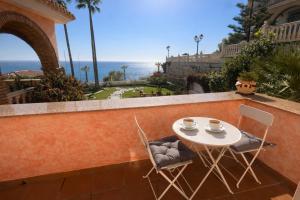a table and chairs on a balcony with a view of the ocean at Villa Alma Boutique Sea View and Pool adults only in Benalmádena