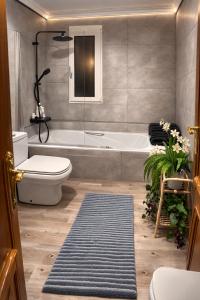 a bathroom with a tub and a toilet and a sink at Villa Alma Boutique Sea View and Pool adults only in Benalmádena +11 photos
