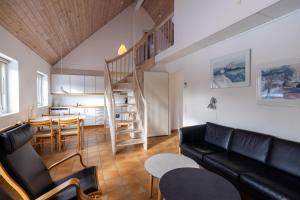 a living room with a couch and a dining room at Skagen Strand Holiday Center in Hulsig