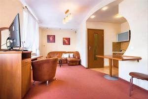 a living room with a television and a couch at IK Apartamenty in Rzeszów +15 photos